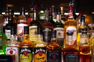 A group of alcohol bottles with the text "Can Muslims Drink Alcohol."